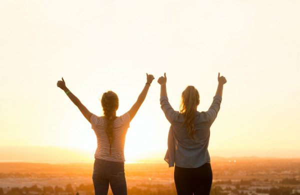 two woman standing near field