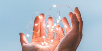 person holding string lights