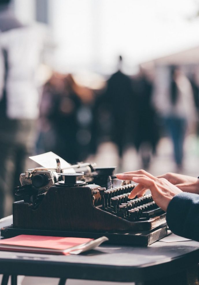 person using black typewriter